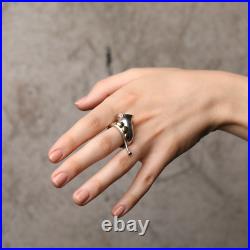 A 925 sterling silver ring in the form of a French horn with brass keys