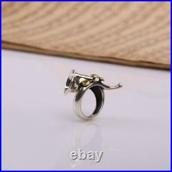 A 925 sterling silver ring in the form of a French horn with brass keys