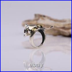 A 925 sterling silver ring in the form of a French horn with brass keys